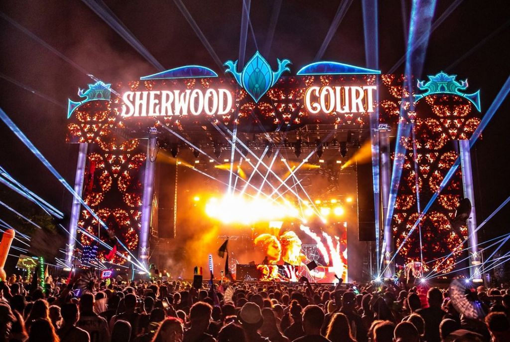  Sherwood Court packed with festival-goers at night during Electric Forest in Rothbury, Michigan.
